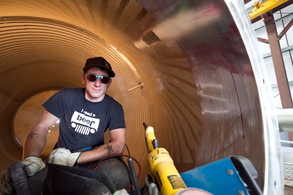 Fabricator at work inside a steel cylinder