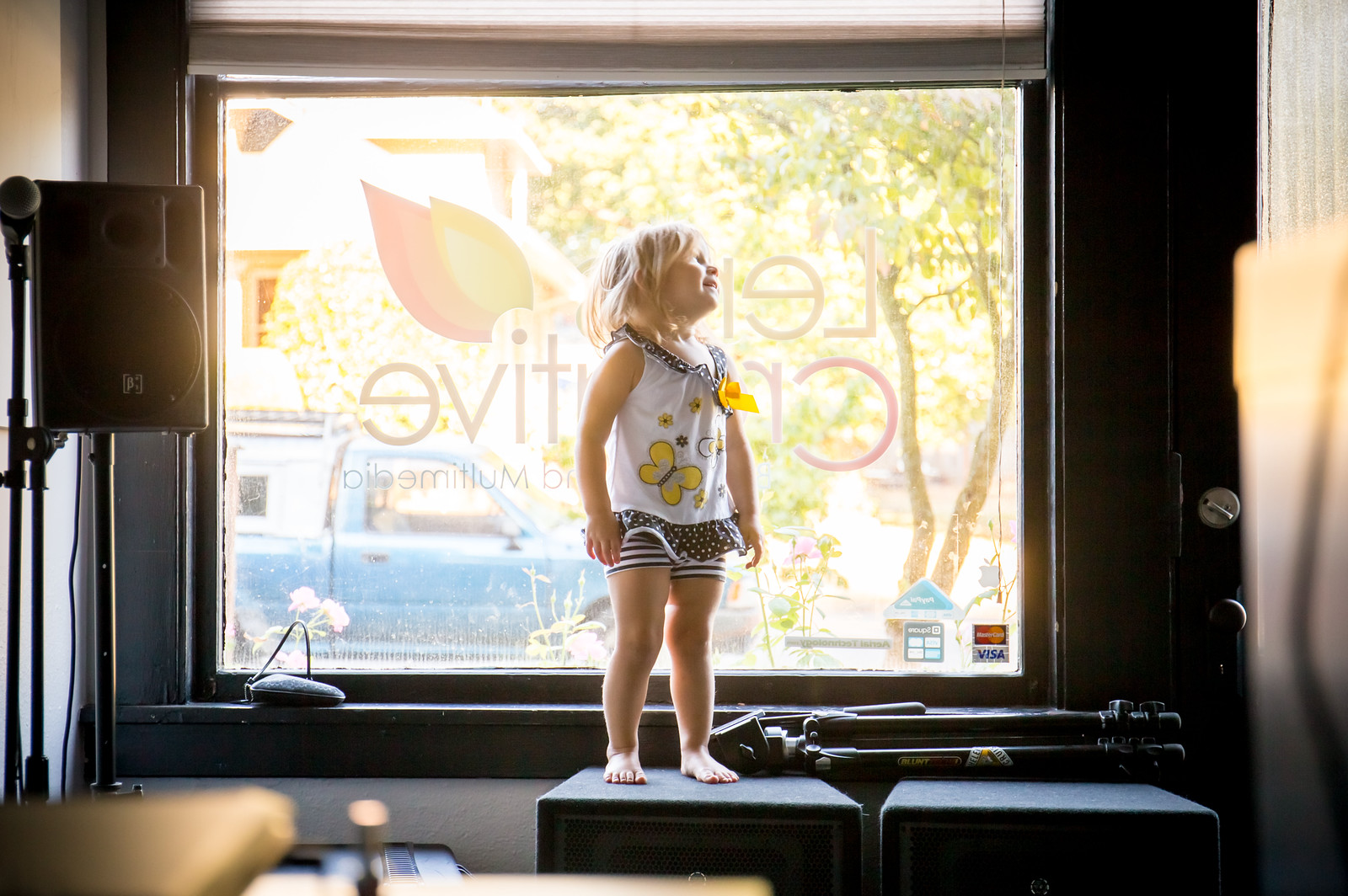 Child silhouetted in a shopfront window